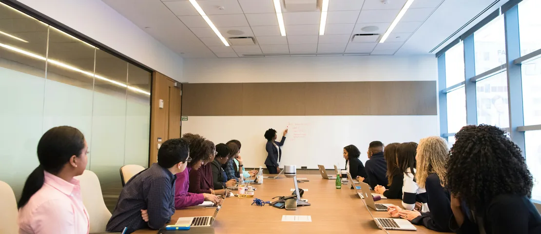 Illustrative photo: a team meeting in a bright office